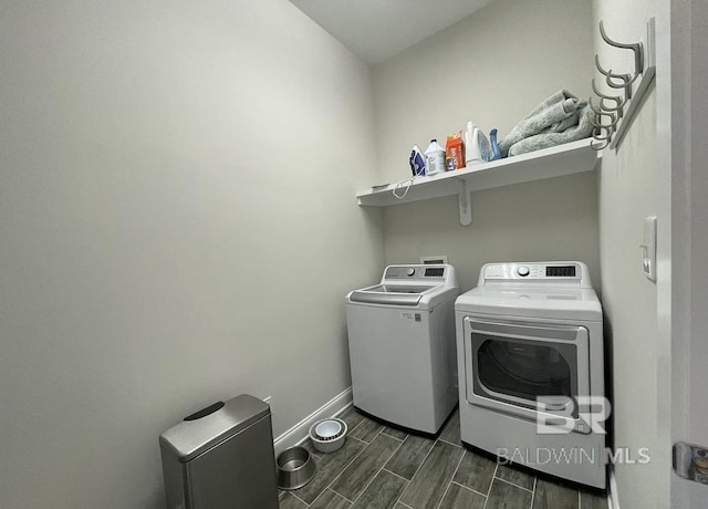 4844 E Cypress Loop, Orange Beach, AL 36561 - washroom with washing machine and dryer, baseboards, and wood tiled floors