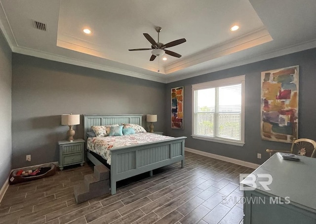 4844 E Cypress Loop, Orange Beach, AL 36561 - bedroom featuring a tray ceiling, crown molding, baseboards, wood tiled floors, and recessed lighting