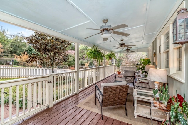 wooden terrace featuring ceiling fan and fence