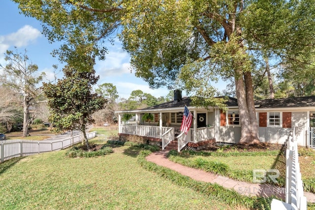 single story home with a chimney, a porch, fence, and a front lawn