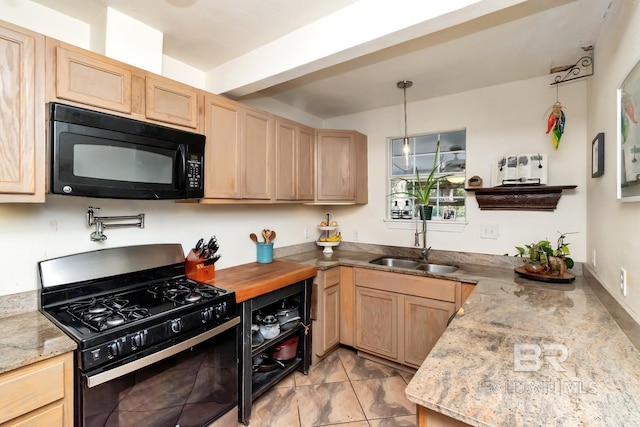 kitchen featuring light brown cabinetry, black microwave, a sink, and gas range oven