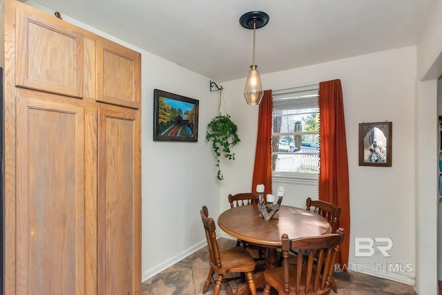 dining area featuring baseboards