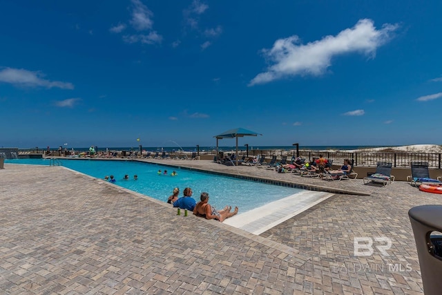 view of pool with a water view