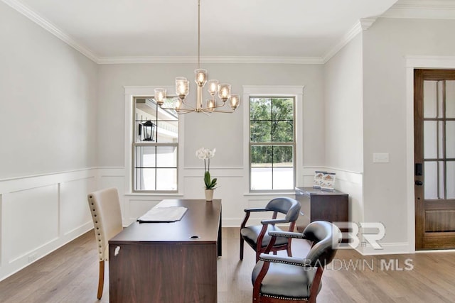 home office with light hardwood / wood-style floors, crown molding, and an inviting chandelier