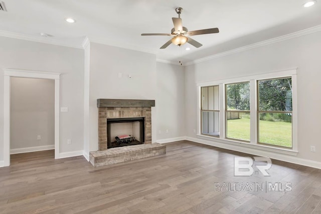 unfurnished living room featuring light hardwood / wood-style floors, a brick fireplace, and ornamental molding