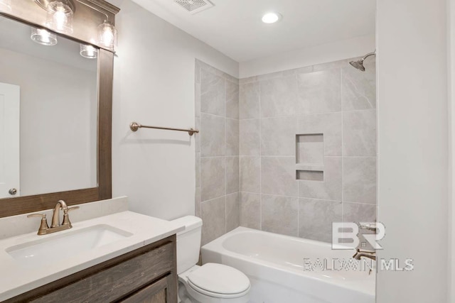 full bathroom featuring vanity, toilet, and tiled shower / bath