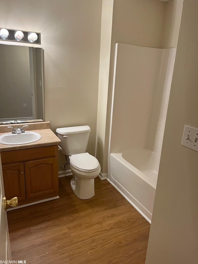 full bathroom with toilet, vanity, shower / bath combination, and hardwood / wood-style flooring