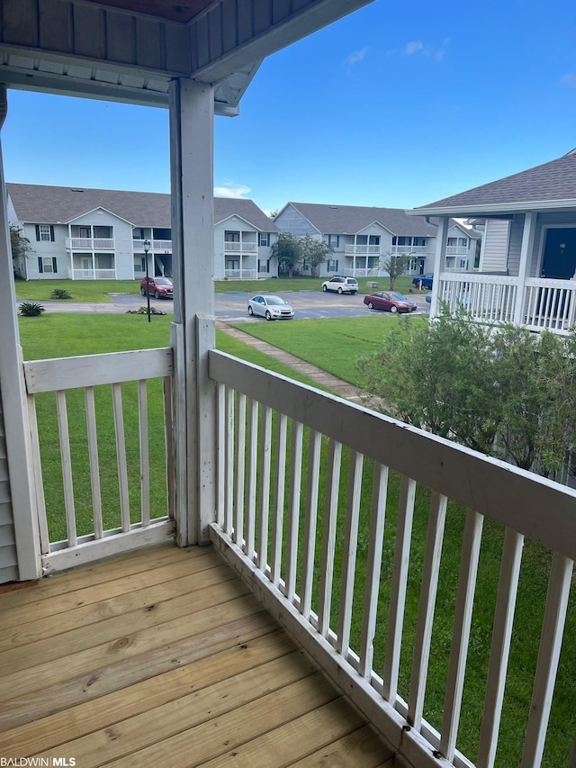 wooden terrace with a lawn