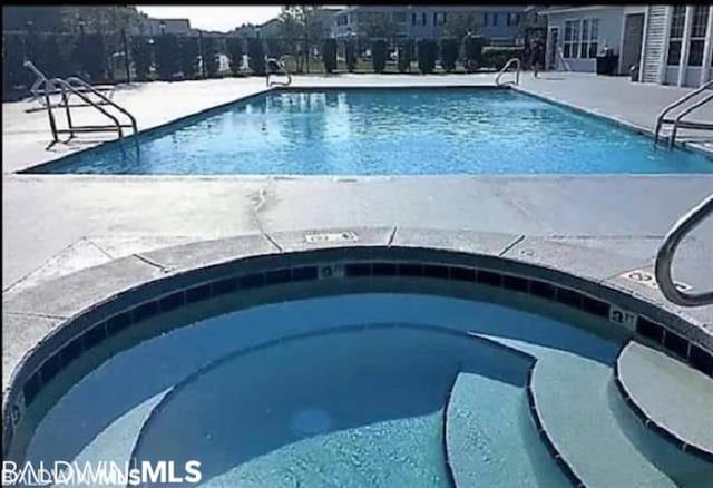 view of pool with a community hot tub