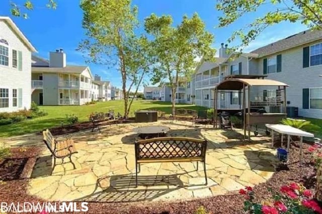 exterior space with an outdoor fire pit and central AC