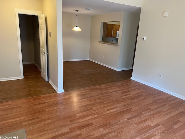 spare room with wood-type flooring