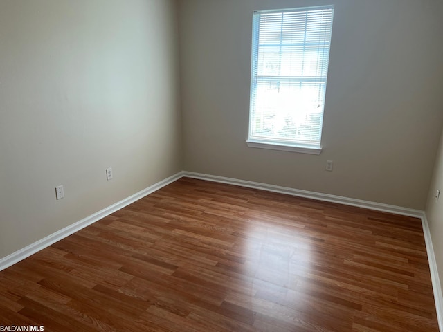 empty room with dark wood-type flooring
