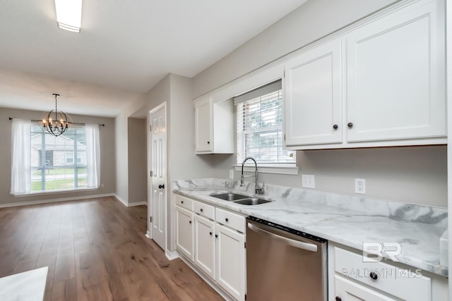 kitchen with pendant lighting, an inviting chandelier, sink, stainless steel dishwasher, and white cabinetry