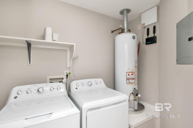washroom featuring water heater, laundry area, electric panel, and washer and dryer