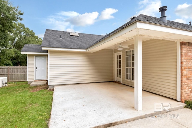 rear view of house with ceiling fan and a patio area