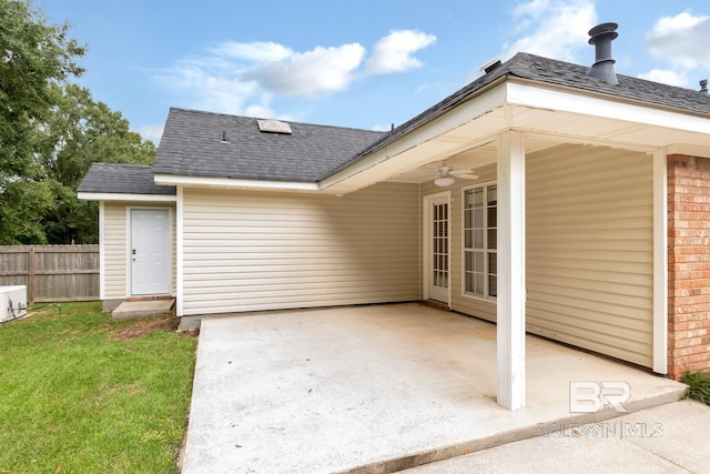 exterior space with fence, a patio, ceiling fan, brick siding, and a shingled roof