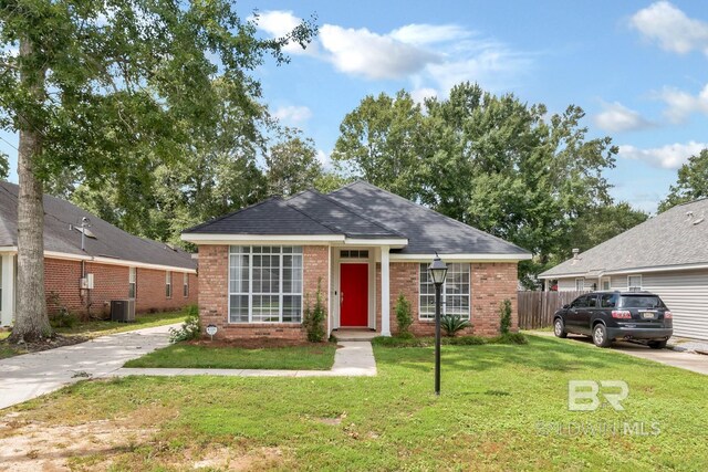 view of front of property featuring a front yard and cooling unit