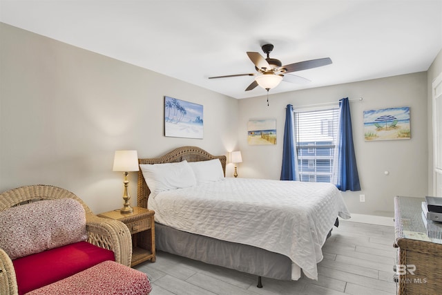 bedroom with light hardwood / wood-style floors and ceiling fan