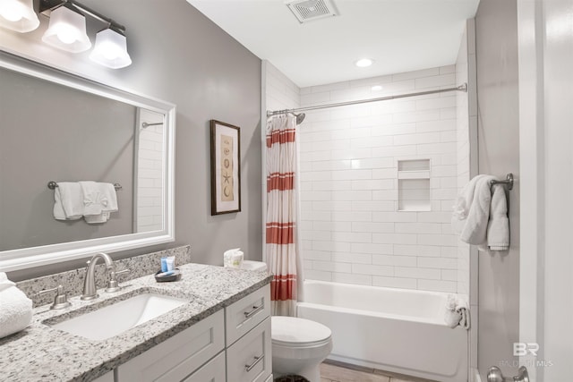 full bathroom featuring toilet, vanity, and shower / tub combo