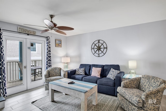 living room featuring ceiling fan, french doors, and light hardwood / wood-style floors