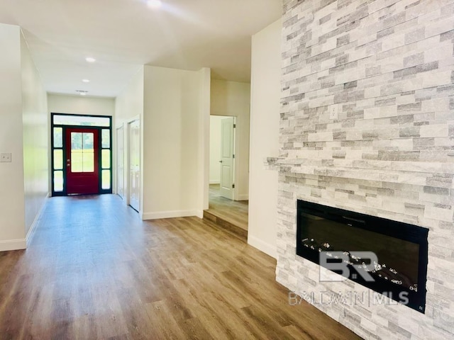 2663 Demetropolis Rd, Mobile, AL 36693 - unfurnished living room with wood finished floors and a stone fireplace