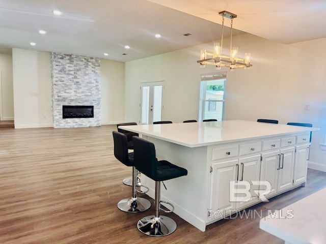 2663 Demetropolis Rd, Mobile, AL 36693 - kitchen with light wood-style floors, a center island, white cabinetry, light countertops, and recessed lighting
