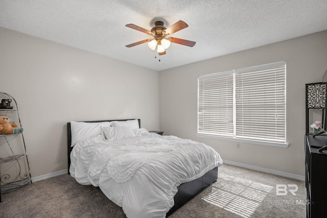 bedroom with light colored carpet, baseboards, ceiling fan, and a textured ceiling