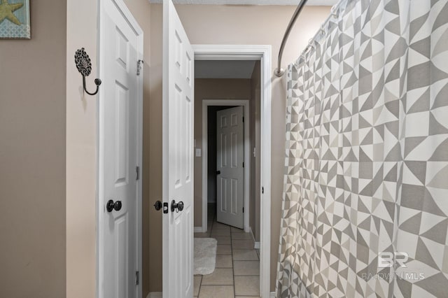 hallway with light tile patterned floors