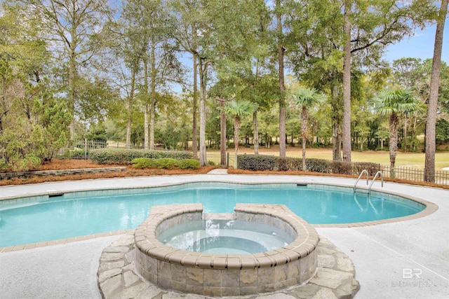 view of pool with an in ground hot tub