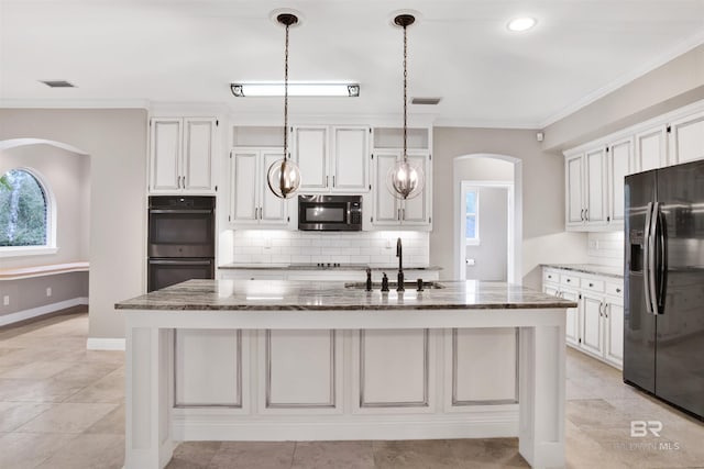 kitchen featuring backsplash, double oven, sink, stone countertops, and fridge with ice dispenser