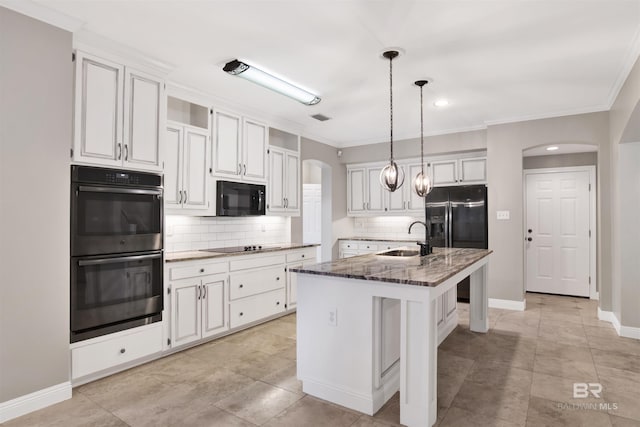 kitchen featuring black appliances, a center island with sink, white cabinetry, and sink