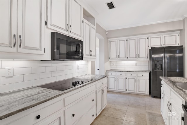 kitchen with backsplash, black appliances, crown molding, light tile patterned flooring, and white cabinetry