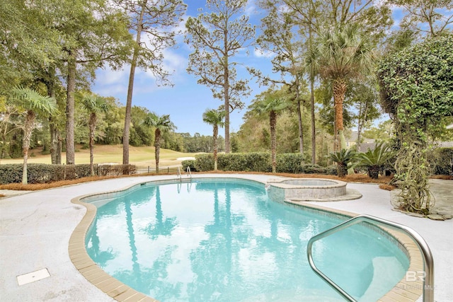 view of pool with an in ground hot tub