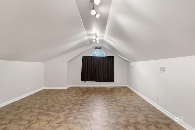 additional living space featuring lofted ceiling