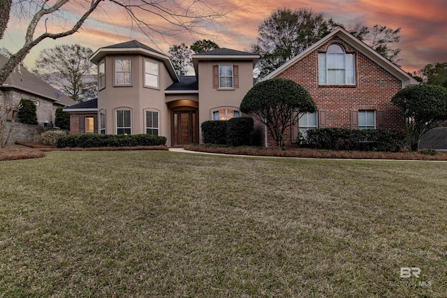 view of front of home featuring a yard and french doors