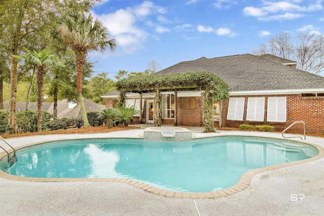 view of pool with an in ground hot tub