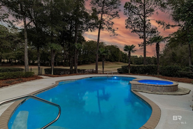 view of pool at dusk