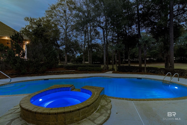 view of swimming pool with an in ground hot tub and a patio