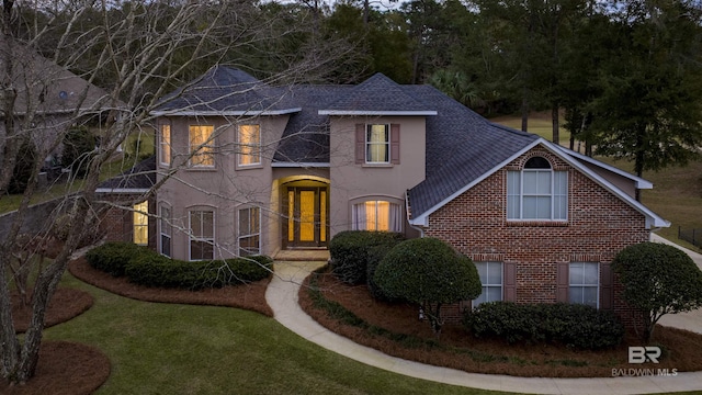 view of front of property with a front yard and french doors