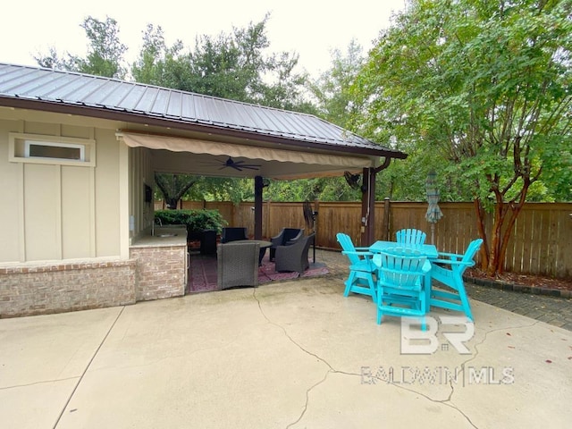 view of patio featuring ceiling fan and fence