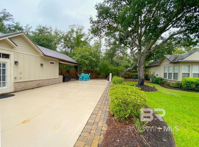 view of yard featuring fence and a patio area