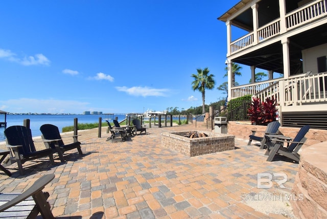 view of patio / terrace featuring a water view and an outdoor fire pit