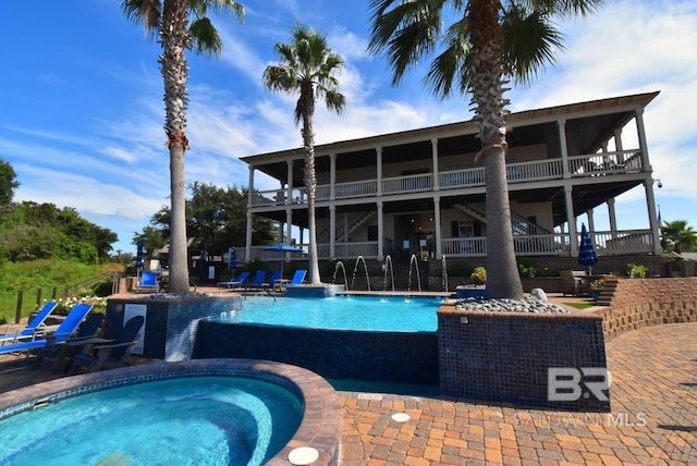 pool with a community hot tub and a patio area