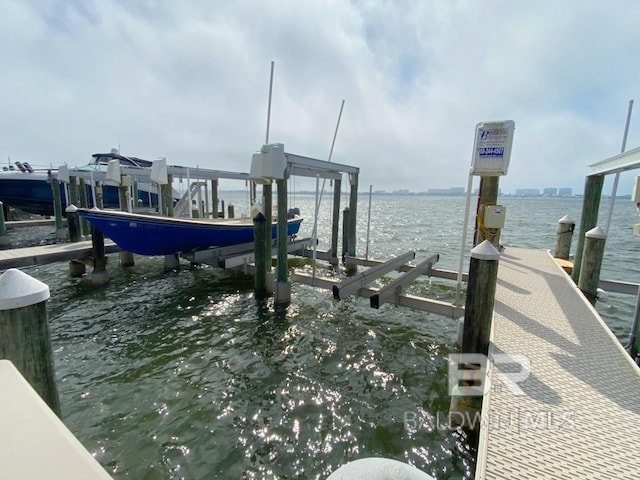view of dock featuring boat lift and a water view
