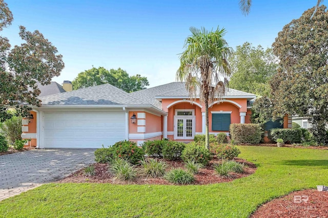 36 Lagoon Dr, Gulf Shores, AL 36542 - single story home featuring roof with shingles, stucco siding, french doors, a front yard, and a garage