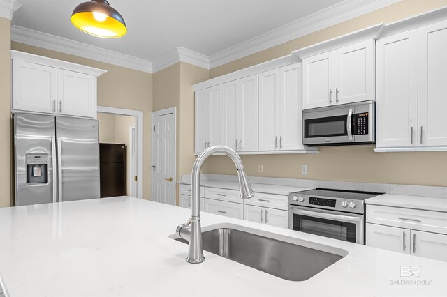 36 Lagoon Dr, Gulf Shores, AL 36542 - kitchen featuring light countertops, a sink, white cabinetry, and stainless steel appliances