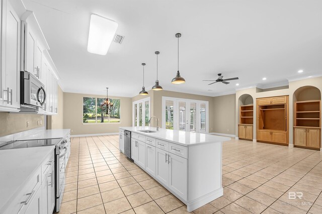 36 Lagoon Dr, Gulf Shores, AL 36542 - kitchen featuring stainless steel appliances, light tile patterned floors, light countertops, and a sink