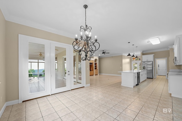 kitchen with decorative light fixtures, ceiling fan with notable chandelier, white cabinetry, and ornamental molding