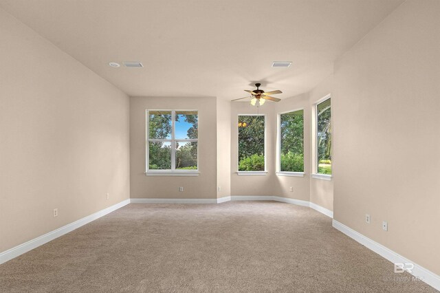 carpeted empty room with ceiling fan