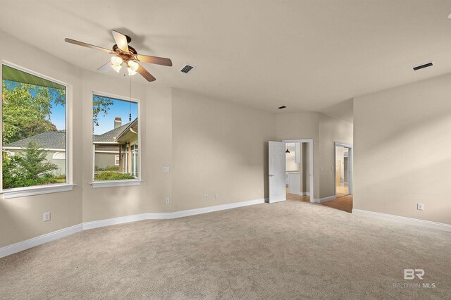 36 Lagoon Dr, Gulf Shores, AL 36542 - unfurnished room featuring carpet flooring, visible vents, a ceiling fan, and a healthy amount of sunlight